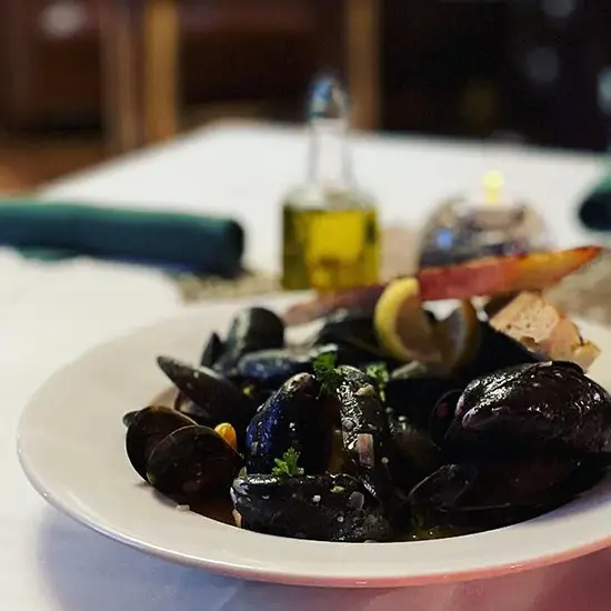 Photo of mussels on a plate on a dining table